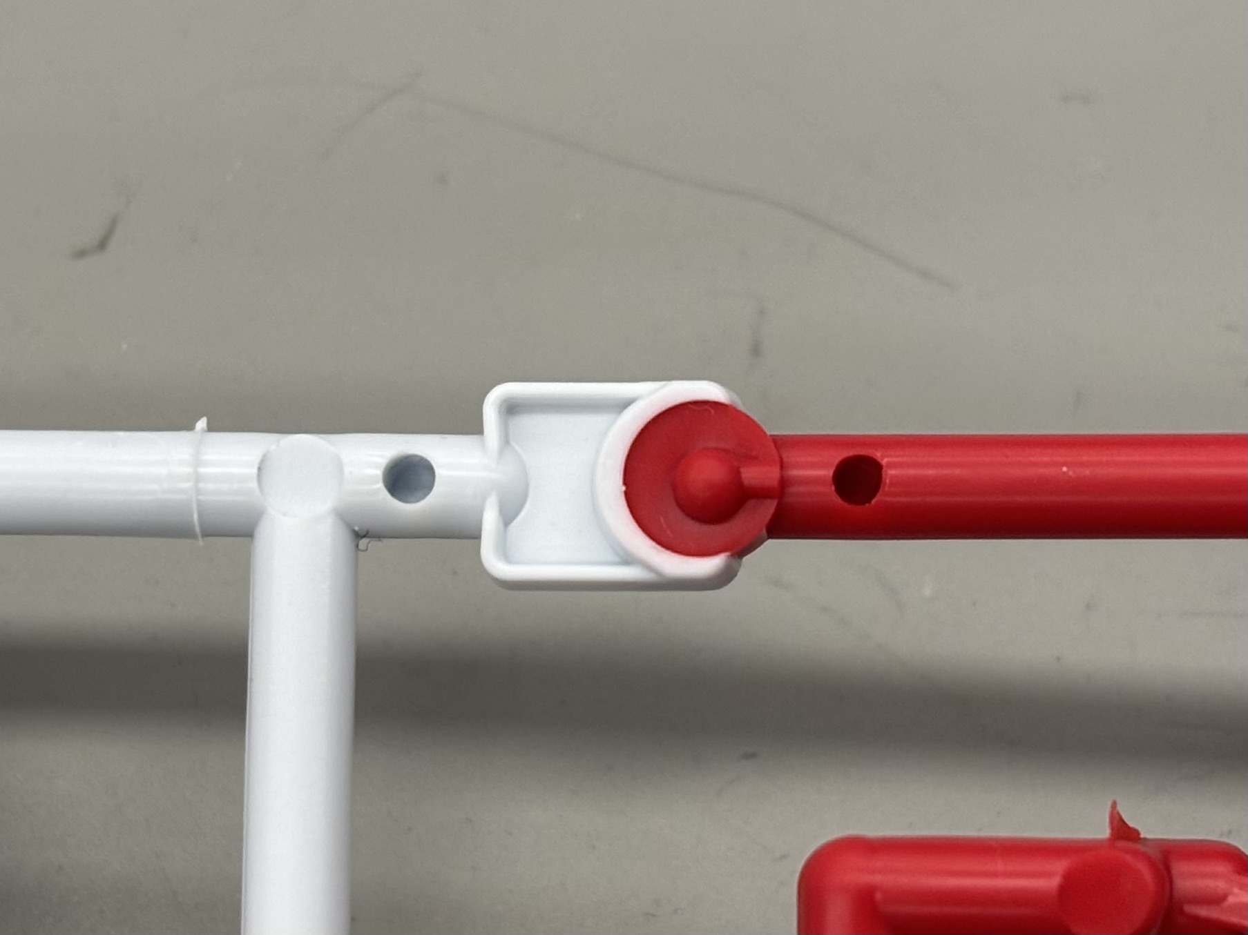 Backside of the red and white color join with core-pin and shutoff geometry.