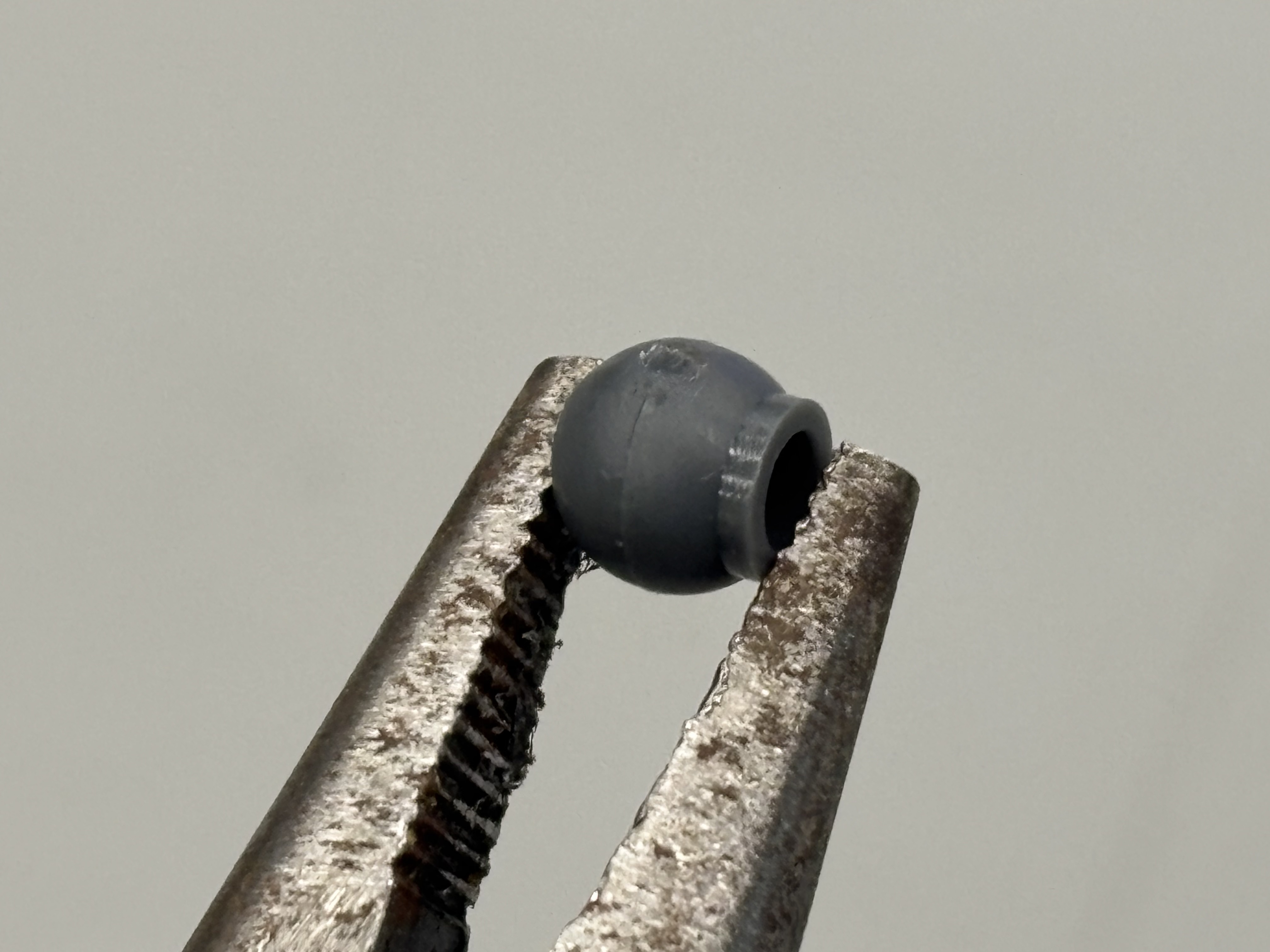 LLDPE polycap held in tweezers.